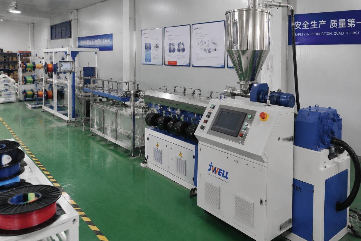 A fully assembled turnkey plastic filament extrusion line running in a small production facility